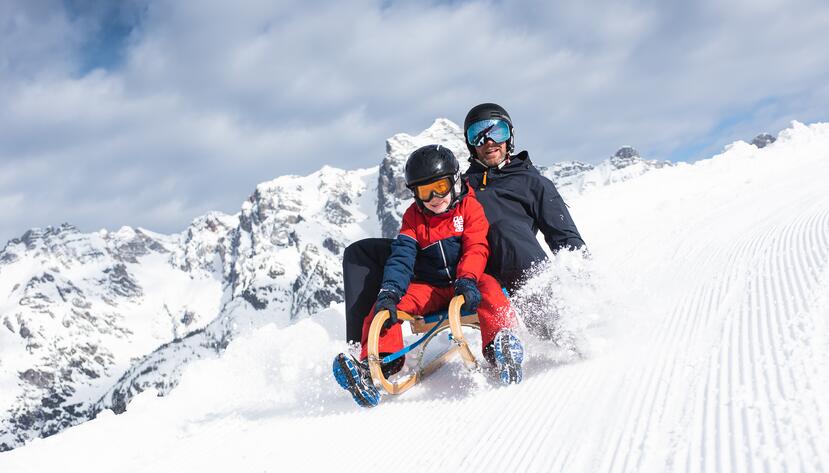 tobogganing with child in Leogang